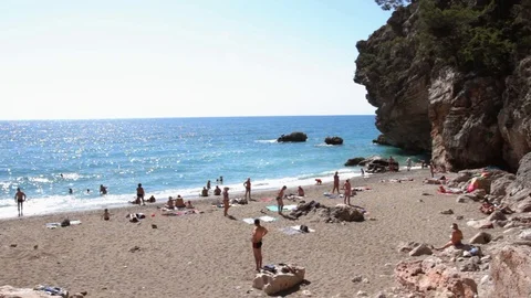 People resting on a wild beach Stock Footage 111358660