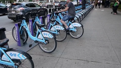 People returning bicycles to a Divvy bikes docking station Chicago city USA Stock Footage 80877523