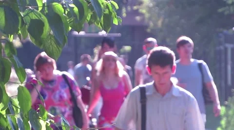 People returning from work through the park Stock Footage 53299958