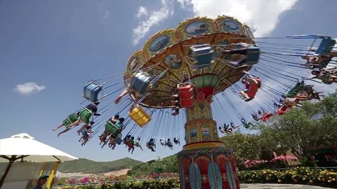 People ride on the carousel. A Chairoplane timelapse with people in the air. Stock Footage 80883321