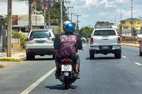 A people ride a motorcycle on the road Stock Photos
