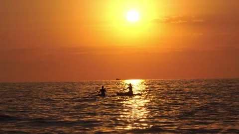 People ride SUP at sunset Stock Footage 247352276