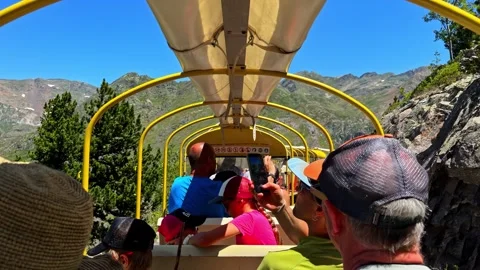 People riding the Artouste train on a sightseeing tour in the Pyrenees mountains Stock Footage 341544399