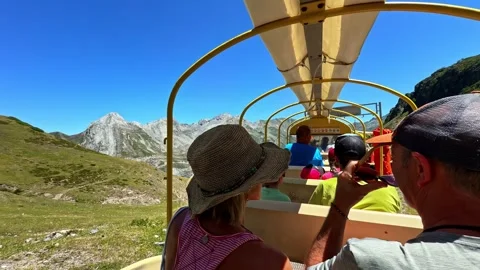 People riding the Artouste train through a mountain tunnel into the sunlight Stock Footage 341544187