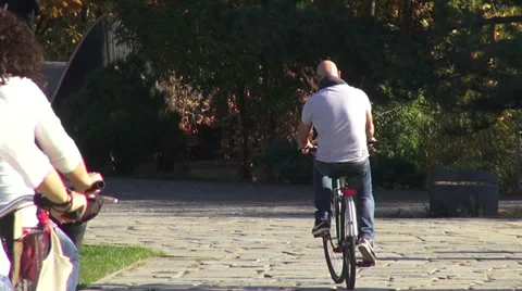 People riding bicycles in the park, fall season, autumn colors Stock Footage 32153265
