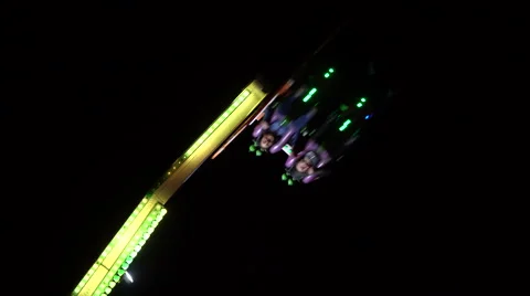 People riding big scary carousel at night Stock Footage 68760153