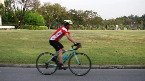 People riding bikes in park Stock Footage 166373167