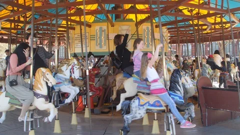 People riding carousel Stock Footage 87924587