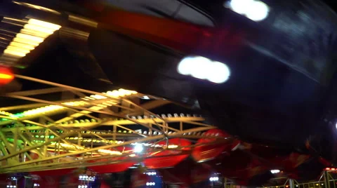 People riding carousel at night Stock Footage 68760367
