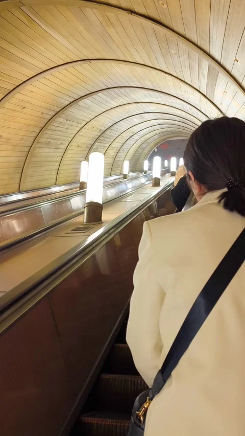 People riding down a long escalator at a beautiful subway station. Stock Footage 337017201