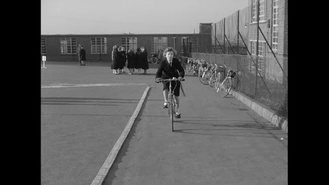 People at riding school practicing their cycling skills, UK 1959 Stock Footage 133383864