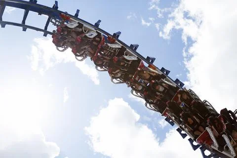 People riding up side down in a roller coaster Stock Photos