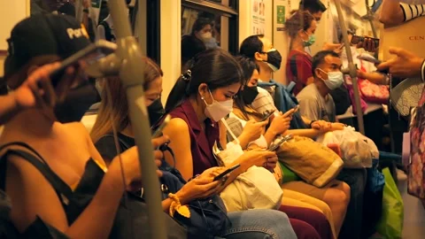 People riding subway train, using mobile phones, wearing Corona-19 face masks Stock Footage 220904121