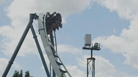 People in a rollercoaster ride going through a spiral at high speed in the Video stock 338071912