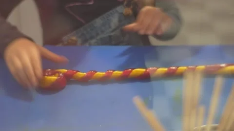 People Rolling a Caramel Strips Making a Candy Rolling a Strips of Caramel up Stock Footage 61545052