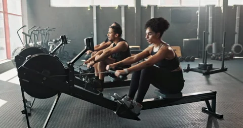 People, rowing machine and gym workout for cardio exercise or fitness teamwork Stock Footage 271109717