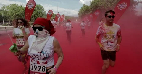 People run through red paint Stock Footage 76556536