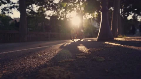 People running and cycling in the street on sunset Stock Footage