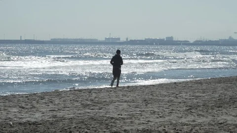 People running on the beach Stock Footage 103470258