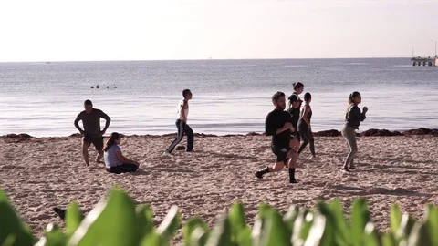 People running on the beach Stock Footage 128088820