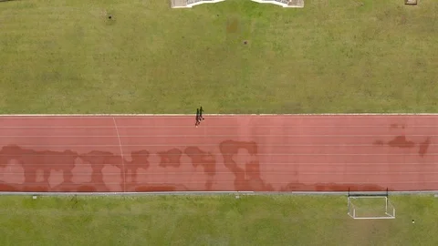 People running for exercise at stadium after rain Video stock 89556496