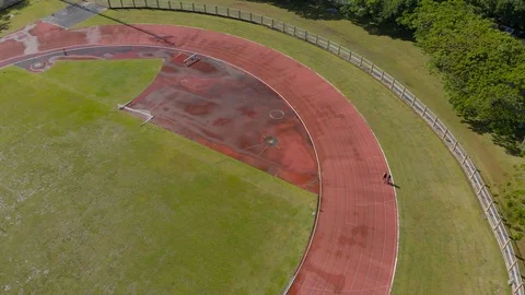 People running for exercise at stadium after rain Stock Footage 89556540