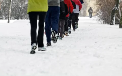 People running in winter park Stock Photos