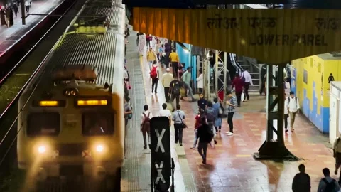 People Rush to Catch Local train passes at Lower Parel Station. 4K (Night View). Stock Footage 247169559