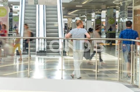 People rush on escalator motion blurred Stock Photos