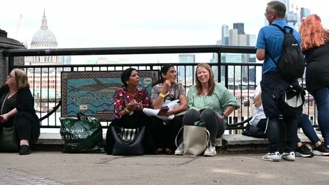 People sat on South Bank in a queue to see the Queen Stock Footage 213235731