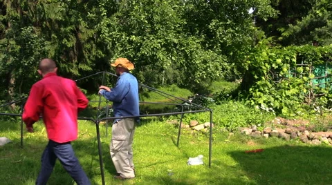 People scarf basic metal gazebo frame rod medium panning view Stock Footage 48600111