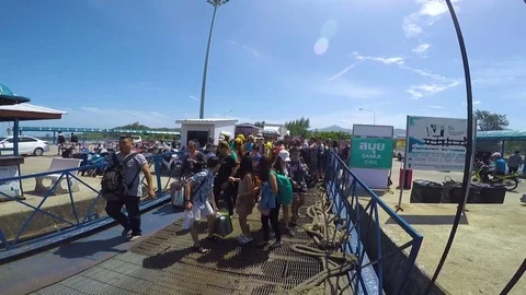 People scramble while waiting at gate ship yard Stock Footage 79485096
