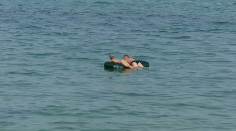 People in the sea on a raft Stock Footage 65615546