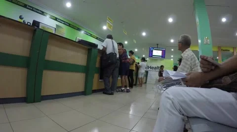 People seated in queue in government office Stock Footage 54568081