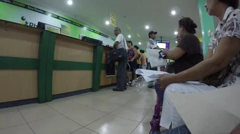 People seated in queue in government office Stock Footage 54568151