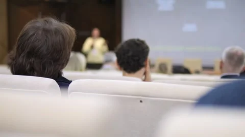 People seated in rows watch presentation Stock Footage 342061409