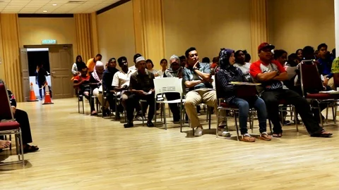 People seated while waiting for their turn. Stock Footage 105286063