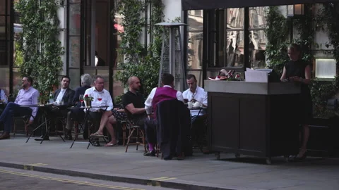 People seating dining and drinking coffee outdoor restaurant in London Stock Footage 146215630