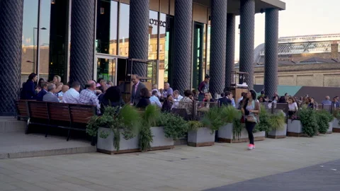 People seating dining and drinking coffee outdoor restaurant in London Stock Footage 146233093