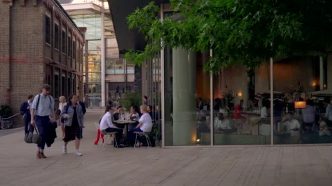 People seating dining and drinking coffee outdoor restaurant in London Stock Footage