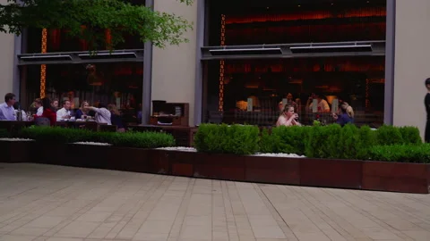 People seating dining and drinking in the main urban outdoor restaurant, London Stock Footage 146237544