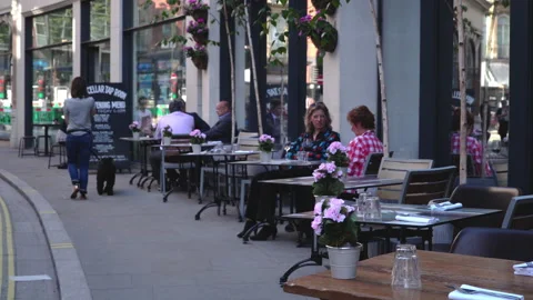 People seating dining and drinking coffee outdoor and restaurant in London Stock Footage 146324970