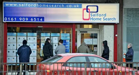 People Seeking Homes Queue Outside Salfords Local Property Shop. Feature On Salf Stock Photos