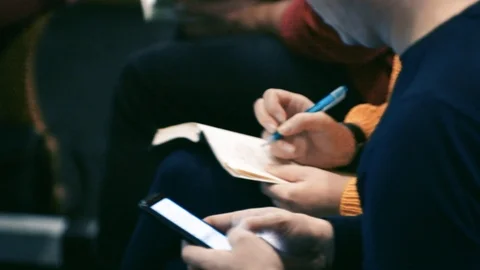 People at a seminar cospect in a notebook Stock Footage 121921545