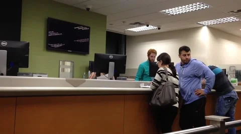 People at a service counter talking to the teller Stock Footage 42752992