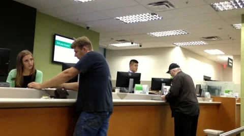 People at service counter talking to the teller Stock Footage 54230651