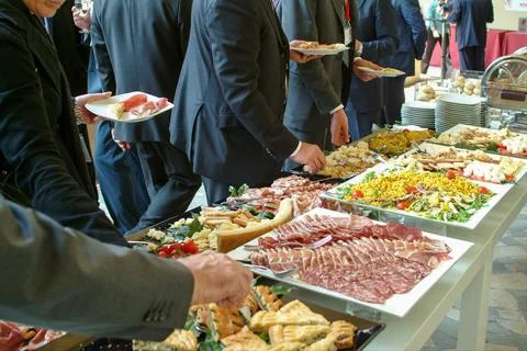 People serving themselves during a buffet Stock Photos