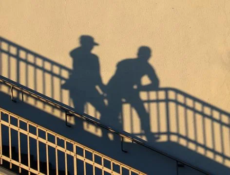 People in the shadow of the sun Stock Photos