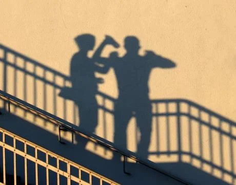 People in the shadow of the sun Stock Photos