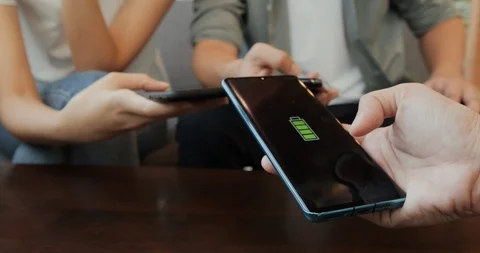 People sharing mobile wireless charge at cafe. Stock Footage 120596330